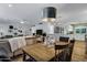 Open-concept dining area showcasing a rustic wooden table with plush seating and adjacent living spaces at 4645 E Cambridge Ave, Phoenix, AZ 85008