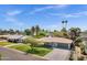 Lovely single-story home with a spacious front yard, mature trees, and a driveway leading to a two-car garage at 4645 E Cambridge Ave, Phoenix, AZ 85008