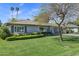 Inviting single-story home featuring a lush green lawn and well-maintained landscaping with mature trees at 4645 E Cambridge Ave, Phoenix, AZ 85008