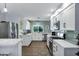 Updated kitchen with white cabinetry, stainless appliances, and stylish green tile backsplash at 4645 E Cambridge Ave, Phoenix, AZ 85008