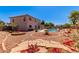 A charming backyard features a pool, beautiful landscaping, rock beds, mature trees, and a patio area for relaxation at 4826 S 26Th Ln, Phoenix, AZ 85041