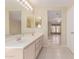 Bright bathroom features double sinks and vanity with adjacent open bedroom view at 4826 S 26Th Ln, Phoenix, AZ 85041