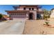 Two-story home with attached garage and desert landscaping at 4826 S 26Th Ln, Phoenix, AZ 85041