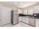 Well-lit kitchen features stainless steel appliances, white cabinetry, and granite countertops at 4826 S 26Th Ln, Phoenix, AZ 85041