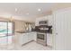 Well-equipped kitchen featuring modern appliances, white cabinetry, and an open layout at 4826 S 26Th Ln, Phoenix, AZ 85041