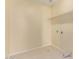 A clean and organized laundry room features tile flooring, wall-mounted shelves, and utility hook-ups for convenience at 4826 S 26Th Ln, Phoenix, AZ 85041