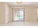 Bright living room featuring sliding glass doors that lead to the backyard pool area at 4826 S 26Th Ln, Phoenix, AZ 85041