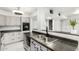 Updated kitchen features stainless steel sink, granite countertops, and white cabinets at 540 N May -- # 1075, Mesa, AZ 85201