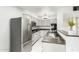 Modern kitchen with stainless steel appliances, granite counters, and bright white cabinets at 540 N May -- # 1075, Mesa, AZ 85201
