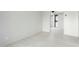 Bright living room with fresh paint and white floors leading to the in-unit laundry at 540 N May -- # 1075, Mesa, AZ 85201