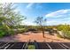 A view of the desert backyard from the roof with trees and a clear, blue sky at 5616 E Desert Vista Trl, Cave Creek, AZ 85331