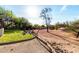 A beautiful backyard featuring a fire pit area, desert landscaping, and grassy area at 5616 E Desert Vista Trl, Cave Creek, AZ 85331