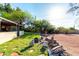 This backyard boasts green grass, desert landscaping, and a cozy fire pit area with seating at 5616 E Desert Vista Trl, Cave Creek, AZ 85331