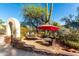 Outdoor seating area featuring desert plants and stone archway at 5616 E Desert Vista Trl, Cave Creek, AZ 85331
