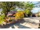 Charming single-story home featuring desert landscaping, a large driveway, and stone accents at 5616 E Desert Vista Trl, Cave Creek, AZ 85331