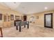 Spacious game room with travertine flooring, custom built-ins, and natural light at 5616 E Desert Vista Trl, Cave Creek, AZ 85331