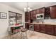 Well-lit eat-in kitchen with dark wood cabinets, granite countertops, and a wine rack for entertaining at 5616 E Desert Vista Trl, Cave Creek, AZ 85331