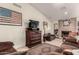 Inviting living room with stone fireplace, travertine floors, entertainment center and ample natural light at 5616 E Desert Vista Trl, Cave Creek, AZ 85331