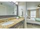 Bathroom featuring granite counters, a dark wood framed mirror, and decoratively folded towels at 5950 N 78Th St # 102, Scottsdale, AZ 85250