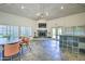 Community center with fireplace, ceiling fan, unique tile flooring, and a wet bar at 5950 N 78Th St # 102, Scottsdale, AZ 85250