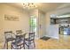 Cozy dining area with glass-top table, seating for four, and view into the adjacent kitchen at 5950 N 78Th St # 102, Scottsdale, AZ 85250