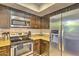 Modern kitchen showcasing stainless steel appliances, granite countertops, and sleek dark cabinetry at 5950 N 78Th St # 102, Scottsdale, AZ 85250
