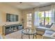 Relaxing living room with stylish gray sectional, entertainment center, and glass coffee table, perfect for lounging at 5950 N 78Th St # 102, Scottsdale, AZ 85250