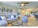 Inviting living room features a comfortable gray sectional sofa, modern decor, and seamless access to the dining area at 5950 N 78Th St # 102, Scottsdale, AZ 85250