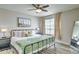 Serene main bedroom with a stylish iron bed frame, desert-themed art, and ample natural light at 5950 N 78Th St # 102, Scottsdale, AZ 85250
