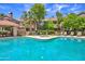 Community pool with spa and lounging area, surrounded by mature trees and well-kept landscaping at 5950 N 78Th St # 102, Scottsdale, AZ 85250