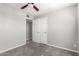 The bedroom has a closet with bifold doors and neutral paint and carpet at 6033 S 19Th Pl, Phoenix, AZ 85042