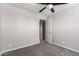 This bedroom has neutral carpet and paint and a ceiling fan at 6033 S 19Th Pl, Phoenix, AZ 85042