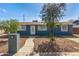 Inviting single-story house with blue exterior, neat front yard, and a charming walkway leading to the entrance at 6033 S 19Th Pl, Phoenix, AZ 85042