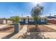 Charming single-story home with blue exterior, landscaped front yard, and a welcoming walkway to the front door at 6033 S 19Th Pl, Phoenix, AZ 85042