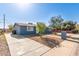 Attractive single-story house with a blue exterior, expansive driveway, and well-kept landscaping offering curb appeal at 6033 S 19Th Pl, Phoenix, AZ 85042