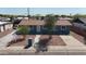 Shot of a blue single-story home with a xeriscaped front yard and concrete driveway at 6033 S 19Th Pl, Phoenix, AZ 85042