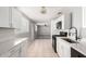 Well-lit kitchen features white cabinets and tile flooring with modern appliances at 6033 S 19Th Pl, Phoenix, AZ 85042