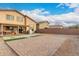 Expansive backyard featuring a large patio area, perfect for outdoor entertaining and relaxation at 6528 S 258Th Dr, Buckeye, AZ 85326