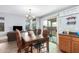 Bright dining area with modern chandelier and sliding door access to the backyard at 6528 S 258Th Dr, Buckeye, AZ 85326