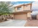 Inviting two-story home featuring desert landscaping and a two-car garage at 6528 S 258Th Dr, Buckeye, AZ 85326