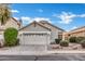 Charming single-story home featuring a two-car garage, desert landscaping, and a neutral color palette at 668 S Catalina St, Gilbert, AZ 85233