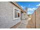 Home exterior featuring a side yard walkway with gravel, concrete, and access to the home's entrance at 668 S Catalina St, Gilbert, AZ 85233
