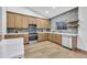 Modern kitchen with stainless steel appliances, stylish backsplash, large island, and hardwood floors at 668 S Catalina St, Gilbert, AZ 85233