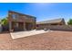 Expansive backyard with a large patio area, gravel landscaping, and a fire pit at 6746 W Wethersfield Rd, Peoria, AZ 85381