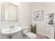 Well-lit powder room with pedestal sink, decorative art, and tile flooring at 6746 W Wethersfield Rd, Peoria, AZ 85381