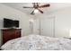 Cozy bedroom with a ceiling fan, TV, and double door closet for ample storage at 6746 W Wethersfield Rd, Peoria, AZ 85381