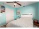 Bedroom features a ceiling fan, closet and aqua walls at 6746 W Wethersfield Rd, Peoria, AZ 85381