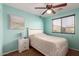 Bedroom features a ceiling fan and aqua walls at 6746 W Wethersfield Rd, Peoria, AZ 85381