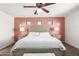 Comfortable bedroom features a queen-size bed, ceiling fan, and unique wall decor at 6746 W Wethersfield Rd, Peoria, AZ 85381