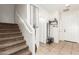 Inviting foyer with staircase, decorative mirror, and tile flooring at 6746 W Wethersfield Rd, Peoria, AZ 85381